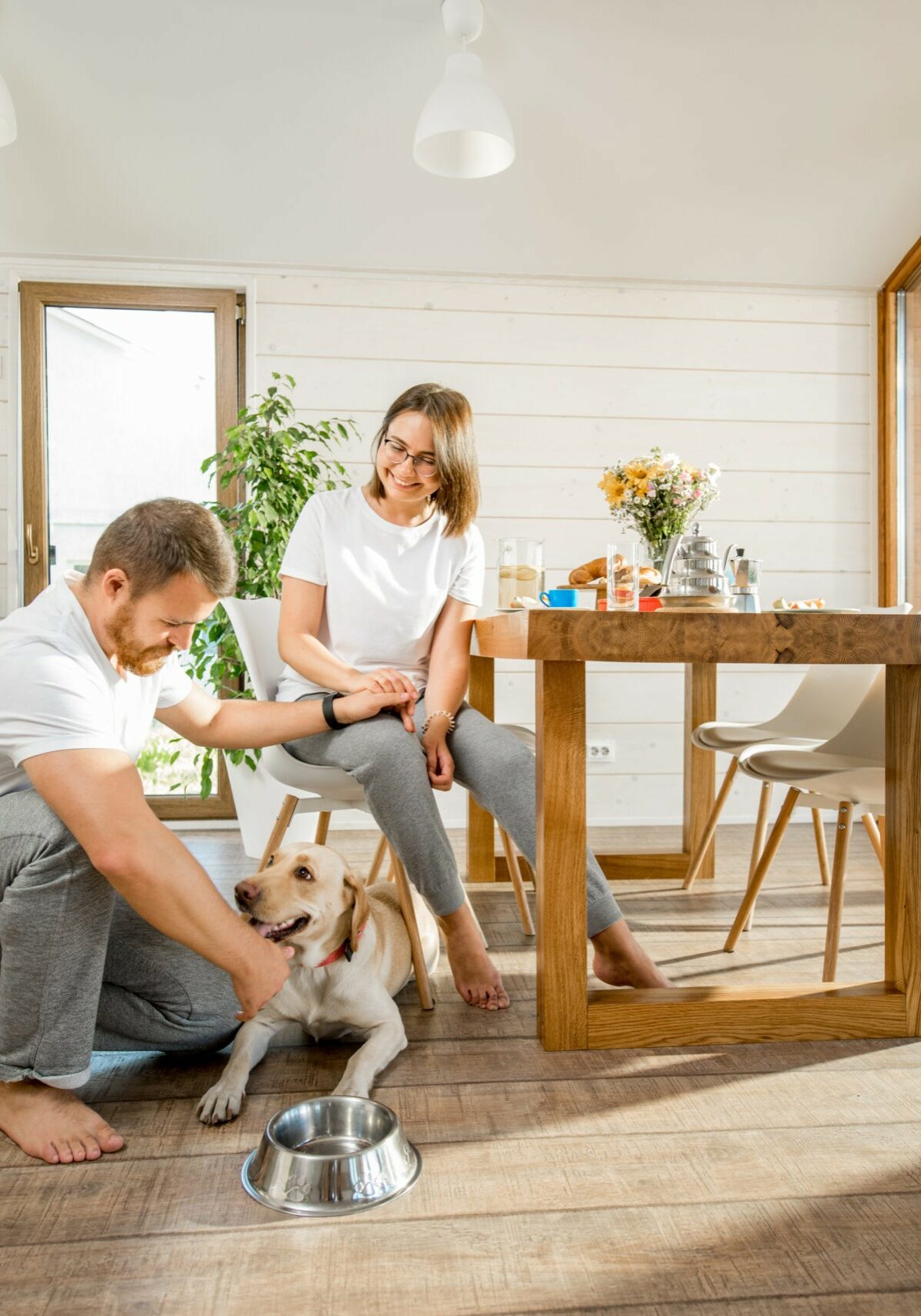 Young couple with dog at home | Floors Of Distinction